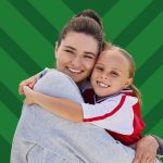Une femme enlace une fillette, toutes les deux souriantes